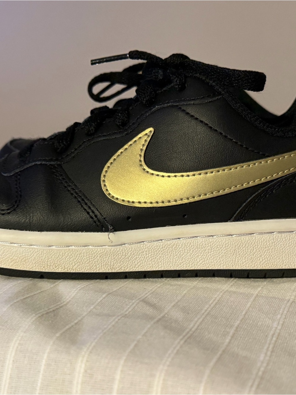 Nike Kids Black Sneakers with Gold Swoosh